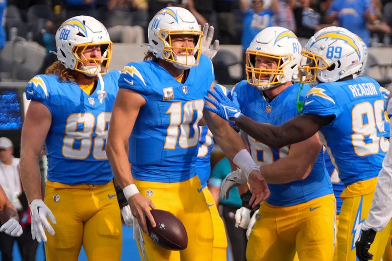 Los Angeles Chargers quarterback Justin Herbert (10) celebrates his touchdown with teammates during the first half of an NFL football game against the Tennessee Titans, Sunday, Nov. 10, 2024, in Inglewood, Calif. (AP Photo/Mark J. Terrill)