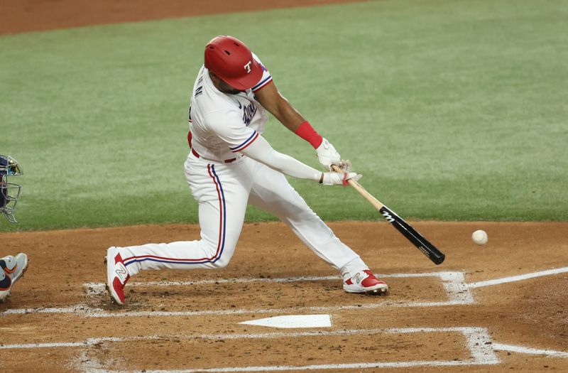 Jun 28, 2023; Arlington, Texas, USA;  Texas Rangers left fielder Ezequiel Duran (20) hits an rbi single during the first inning against the Detroit Tigers at Globe Life Field. Mandatory Credit: Kevin Jairaj-USA TODAY Sports