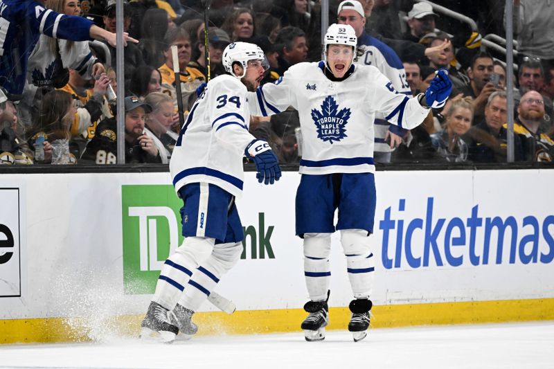 Apr 22, 2024; Boston, Massachusetts, USA; Toronto Maple Leafs center Auston Matthews (34) reacts with left wing Tyler Bertuzzi (59) after scoring a goal against the Boston Bruins during the third period in game two of the first round of the 2024 Stanley Cup Playoffs at TD Garden. Mandatory Credit: Brian Fluharty-USA TODAY Sports