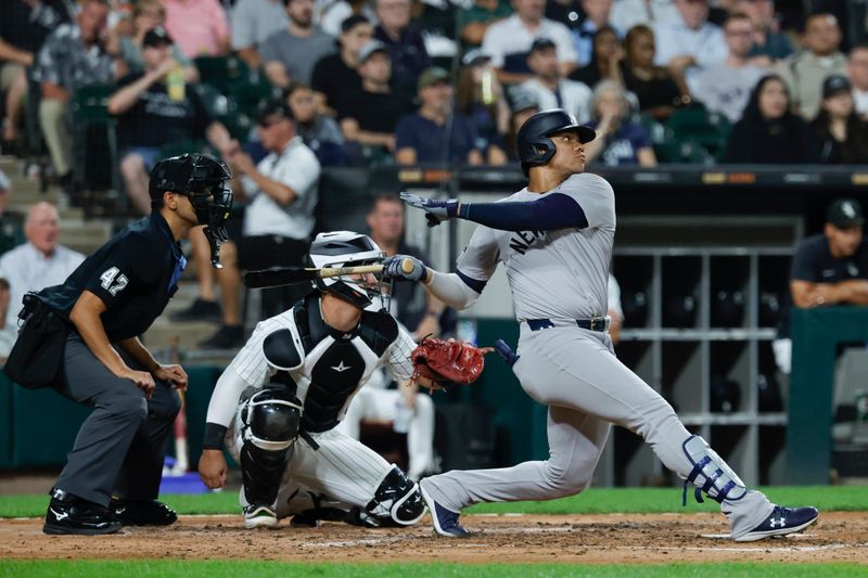 Aug 13, 2024; Chicago, Illinois, USA; New York Yankees outfielder Juan Soto (22) hits a solo home run against the Chicago White Sox during the fifth inning at Guaranteed Rate Field. Mandatory Credit: Kamil Krzaczynski-USA TODAY Sports