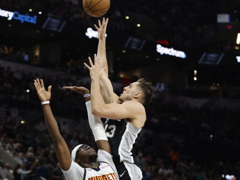 SAN ANTONIO, TX - APRIL 12: Zach Collins #23 of the San Antonio Spurs shots over Reggie Jackson #7 of the Denver Nuggets in the first half at Frost Bank Center on April 12, 2024 in San Antonio, Texas. NOTE TO USER: User expressly acknowledges and agrees that, by downloading and or using this photograph, User is consenting to terms and conditions of the Getty Images License Agreement. (Photo by Ronald Cortes/Getty Images)