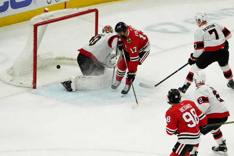 Feb 17, 2024; Chicago, Illinois, USA; Chicago Blackhawks left wing Nick Foligno (17) scores a goal on Ottawa Senators goaltender Joonas Korpisalo (70) during the first period at United Center. Mandatory Credit: David Banks-USA TODAY Sports