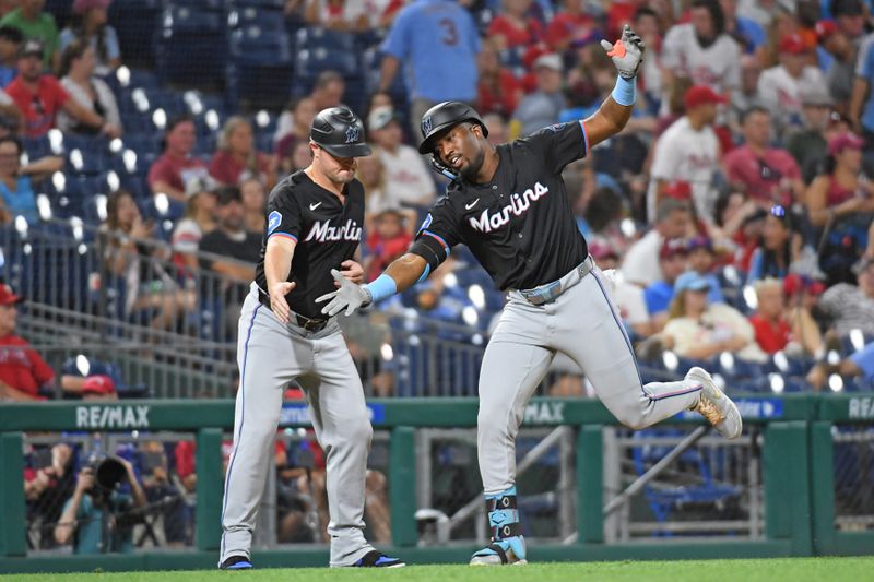 Aug 13, 2024; Philadelphia, Pennsylvania, USA; Miami Marlins outfielder Jesús Sánchez (12) celebrates his home run with Miami Marlins third base coach Griffin Benedict (81) during the ninth inning against the Philadelphia Phillies at Citizens Bank Park. Mandatory Credit: Eric Hartline-USA TODAY Sports