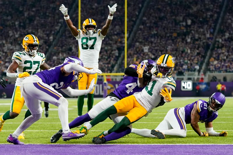 Green Bay Packers' Jayden Reed gets into the end zone after a catch during the first half of an NFL football game against the Minnesota Vikings Sunday, Dec. 31, 2023, in Minneapolis. (AP Photo/Abbie Parr)