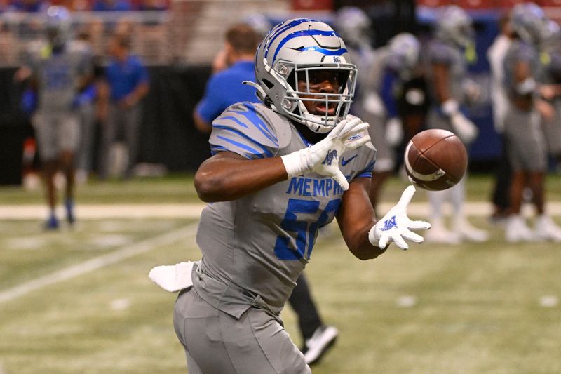 Sep 23, 2023; St. Louis, Missouri, USA; Memphis Tigers offensive lineman Davion Carter (56) makes a catch during warm up prior to a game against the Missouri Tigers at The Dome at America's Center. Mandatory Credit: Joe Puetz-USA TODAY Sports