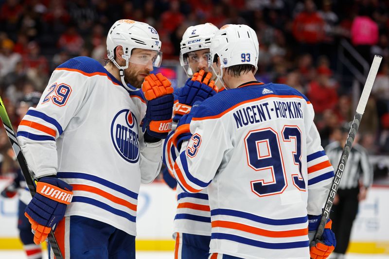 Nov 24, 2023; Washington, District of Columbia, USA; Edmonton Oilers defenseman Evan Bouchard (2) talks with Oilers center Leon Draisaitl (29) and Oilers center Ryan Nugent-Hopkins (93) prior to a face-off against the Washington Capitals second period at Capital One Arena. Mandatory Credit: Geoff Burke-USA TODAY Sports