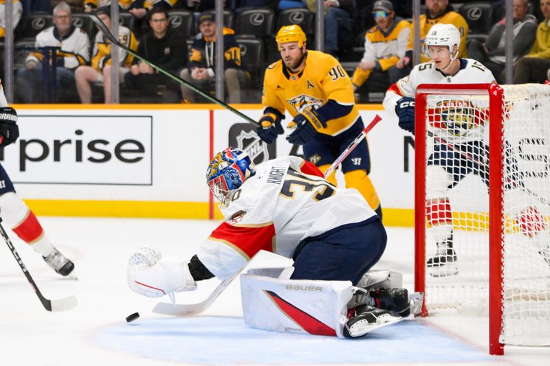 Feb 25, 2025; Nashville, Tennessee, USA;  Florida Panthers goaltender Spencer Knight (30) dives for the puck against the Nashville Predators during the first period at Bridgestone Arena. Mandatory Credit: Steve Roberts-Imagn Images