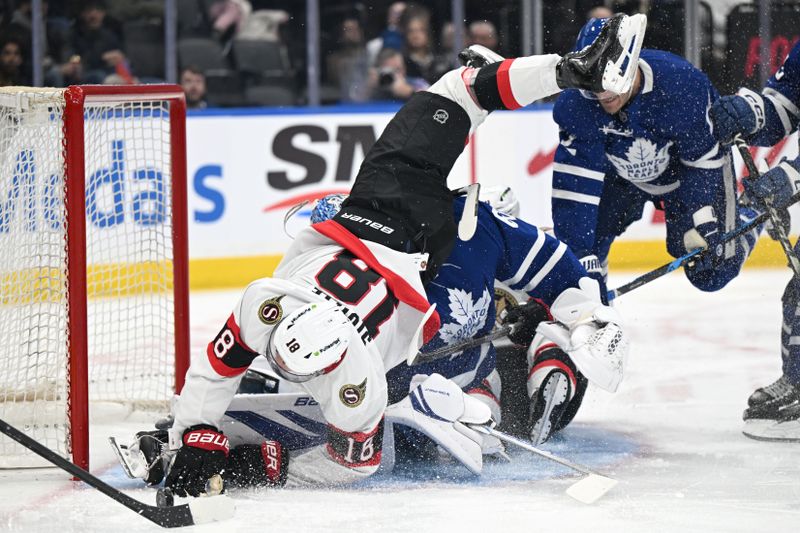 Feb 28, 2026; Toronto, Ontario, CAN;  Ottawa Senators forward Tim Stutzle (18) falls over Toronto Maple Leafs goalie Joseph Woll (60) as he pursues the puck in the second period at Scotiabank Arena. Mandatory Credit: Dan Hamilton-Imagn Images