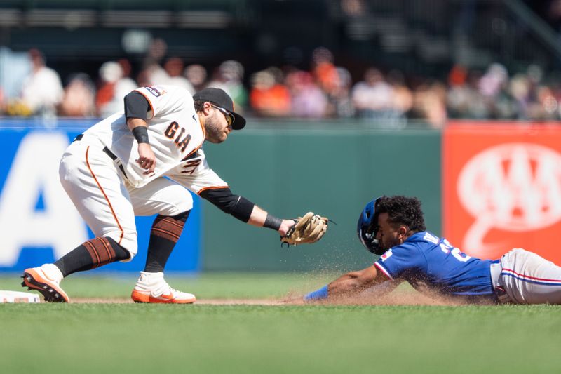 Aug 13, 2023; San Francisco, California, USA; San Francisco Giants shortstop Brandon Crawford (35) tags out Texas Rangers shortstop Ezequiel Duran (20) during the ninth inning at Oracle Park. Mandatory Credit: Stan Szeto-USA TODAY Sports