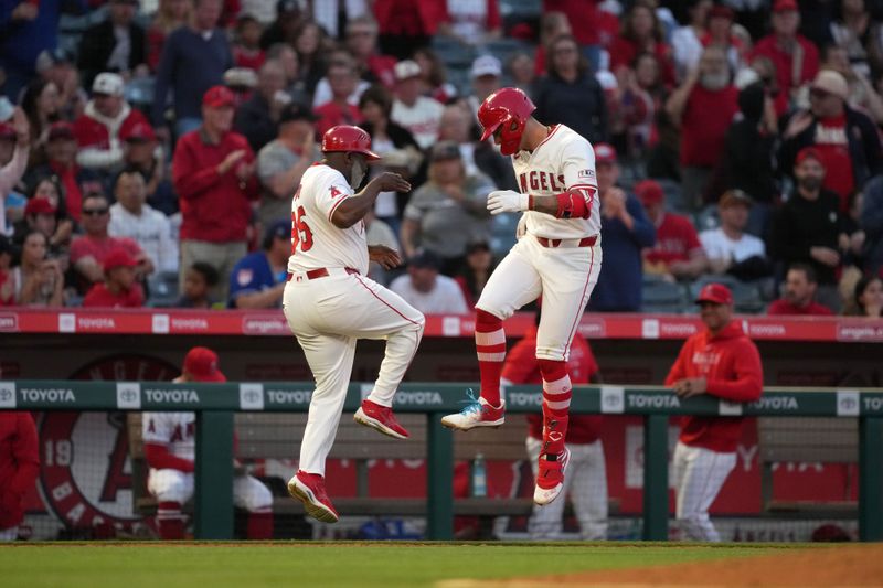 Apr 30, 2024; Anaheim, California, USA; Los Angeles Angels shortstop Zach Neto (9) celebrates with third base coach Eric Young Sr. (85) after hitting a home run in the third inning against the Philadelphia Phillies at Angel Stadium. Mandatory Credit: Kirby Lee-USA TODAY Sports