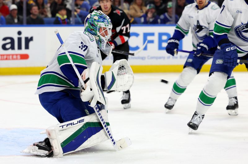 Nov 29, 2024; Buffalo, New York, USA;  Vancouver Canucks goaltender Kevin Lankinen (32) looks to make a glove save during the second period against the Buffalo Sabres at KeyBank Center. Mandatory Credit: Timothy T. Ludwig-Imagn Images