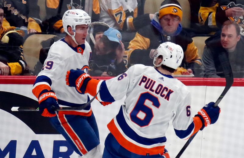 Feb 20, 2024; Pittsburgh, Pennsylvania, USA; New York Islanders center Brock Nelson (29) celebrates with defenseman Ryan Pulock (6) after Nelson scored a goal against the Pittsburgh Penguins during the second period at PPG Paints Arena. Mandatory Credit: Charles LeClaire-USA TODAY Sports