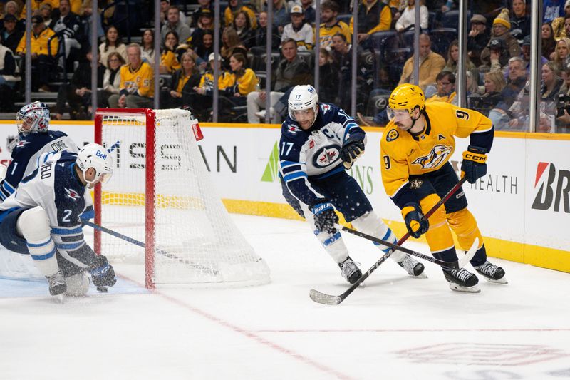 Nov 23, 2024; Nashville, Tennessee, USA;  Winnipeg Jets defenseman Dylan DeMelo (2) blocks the shot of Nashville Predators left wing Filip Forsberg (9) during the third period at Bridgestone Arena. Mandatory Credit: Steve Roberts-Imagn Images