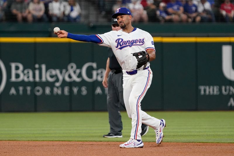 Apr 25, 2024; Arlington, Texas, USA; Texas Rangers second baseman Marcus Semien (2) throws to first base during the fourth inning against the Seattle Mariners at Globe Life Field. Mandatory Credit: Raymond Carlin III-USA TODAY Sports