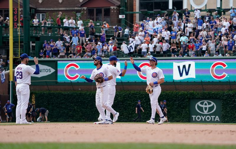 Jun 22, 2024; Chicago, Illinois, USA;  The Chicago Cubs celebrate their win against the New York Mets at Wrigley Field. Mandatory Credit: David Banks-USA TODAY Sports