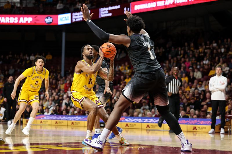 Feb 1, 2025; Minneapolis, Minnesota, USA; Minnesota Golden Gophers guard Femi Odukale (11) shoots as Washington Huskies forward Great Osobor (1) defends during the first half at Williams Arena. Mandatory Credit: Matt Krohn-Imagn Images