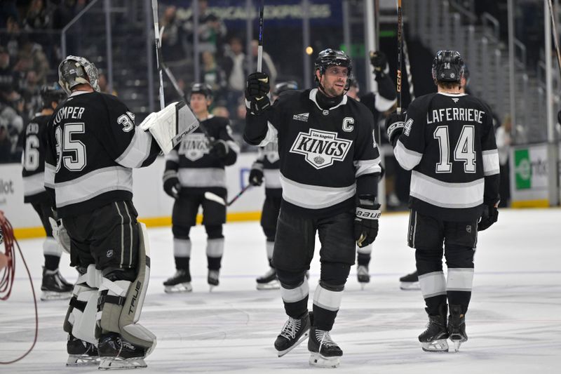 Apr 12, 2025; Los Angeles, California, USA; Los Angeles Kings goaltender Darcy Kuemper (35), center Anze Kopitar (11) and right wing Alex Laferriere (14) celebrate at center ice following the game against the Colorado Avalanche at Crypto.com Arena. Mandatory Credit: Jayne Kamin-Oncea-Imagn Images
