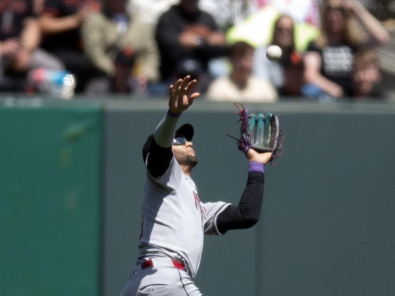 May 14, 2025; San Francisco, California, USA; Arizona Diamondbacks left fielder Lourdes Gurriel Jr. (12) makes a running catch of a fly ball by San Francisco Giants center fielder Jung Hoo Lee during the fifth inning at Oracle Park. Mandatory Credit: D. Ross Cameron-Imagn Images