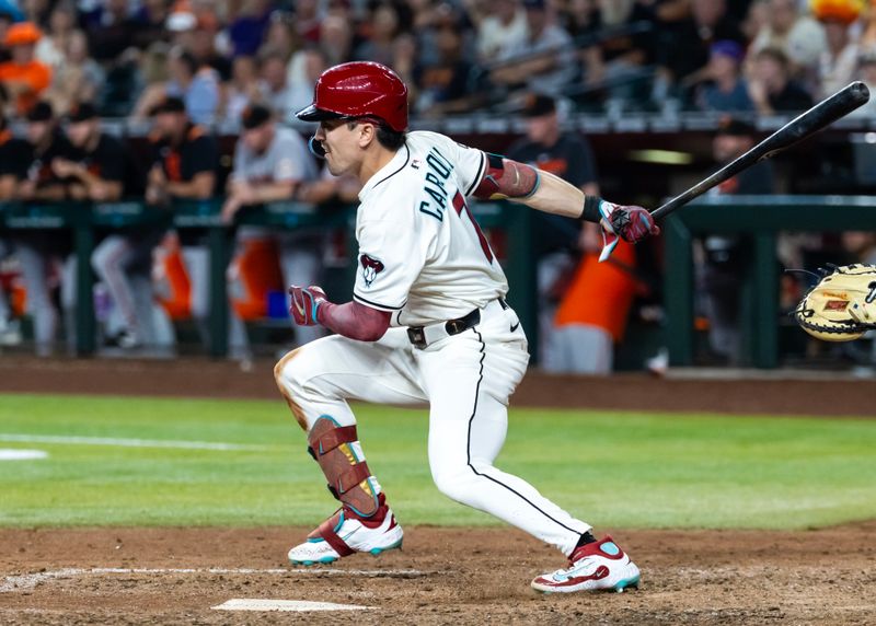 Sep 16, 2025; Phoenix, Arizona, USA; Arizona Diamondbacks outfielder Corbin Carroll hits a ninth inning single against the San Francisco Giants at Chase Field. Mandatory Credit: Mark J. Rebilas-Imagn Images