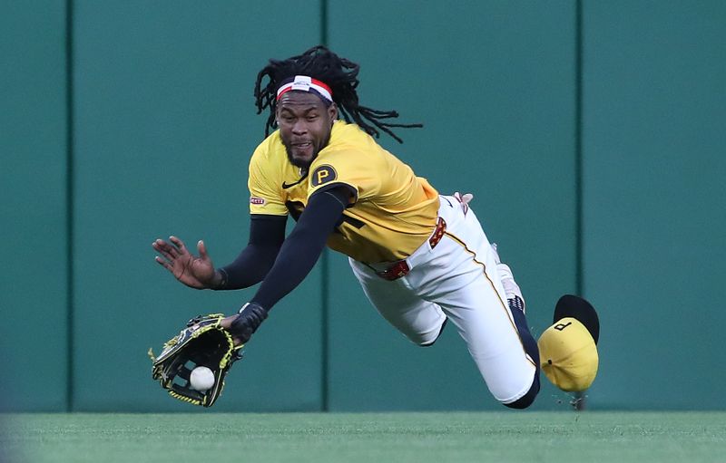 May 23, 2025; Pittsburgh, Pennsylvania, USA;  Pittsburgh Pirates center fielder Oneil Cruz (15) dives but fails to catch a ball hit for an RBI single by Milwaukee Brewers first baseman Rhys Hoskins (not pictured) during the sixth inning at PNC Park. Mandatory Credit: Charles LeClaire-Imagn Images