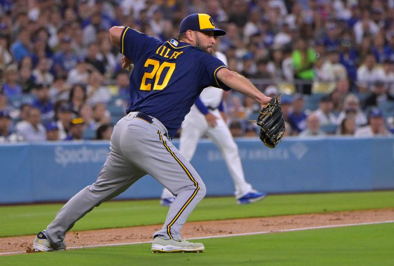 Aug 16, 2023; Los Angeles, California, USA;  Milwaukee Brewers starting pitcher Wade Miley (20) reacts after slipping on the grass as he attempts a throw to first on an infield hit by Los Angeles Dodgers catcher Will Smith (16) in the second inning at Dodger Stadium. Mandatory Credit: Jayne Kamin-Oncea-USA TODAY Sports