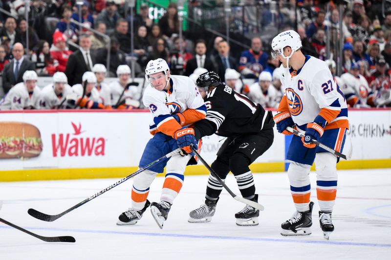Feb 5, 2026; Newark, New Jersey, USA; New York Islanders center Mathew Barzal (13) passes against New Jersey Devils right wing Connor Brown (16) during the first period at Prudential Center. Mandatory Credit: John Jones-Imagn Images