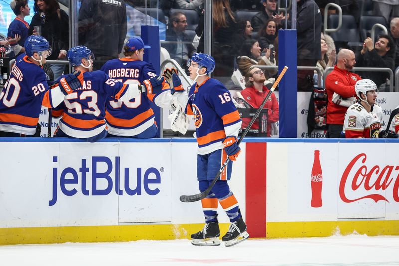 Mar 16, 2025; Elmont, New York, USA;  New York Islanders center Marc Gatcomb (16) celebrates with his teammates after scoring a goal in the third period against the Florida Panthers at UBS Arena. Mandatory Credit: Wendell Cruz-Imagn Images