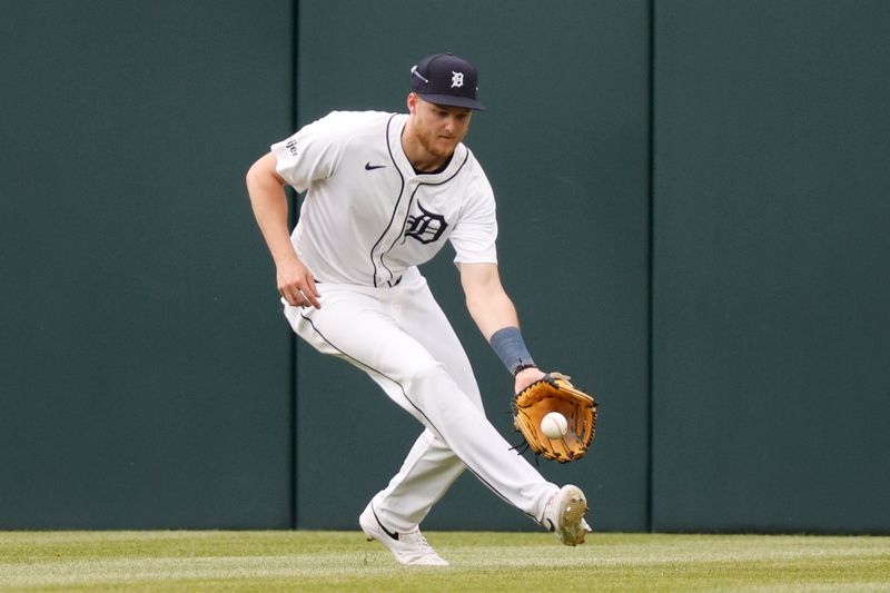 Apr 17, 2024; Detroit, Michigan, USA; Detroit Tigers outfielder Parker Meadows (22) recovers a ground ball during the ninth inning against the Texas Rangers at Comerica Park. Mandatory Credit: Brian Bradshaw Sevald-USA TODAY Sports