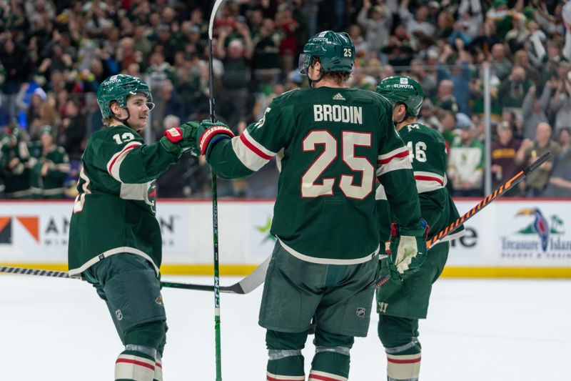 Apr 8, 2023; Saint Paul, Minnesota, USA; Minnesota Wild defenseman Jonas Brodin (25) is congratulated by center Sam Steel (13) and defenseman Jared Spurgeon (46) after scoring on the St. Louis Blues' open net from the Minnesota Wild defensive zone in the third period at Xcel Energy Center. Mandatory Credit: Matt Blewett-USA TODAY Sports