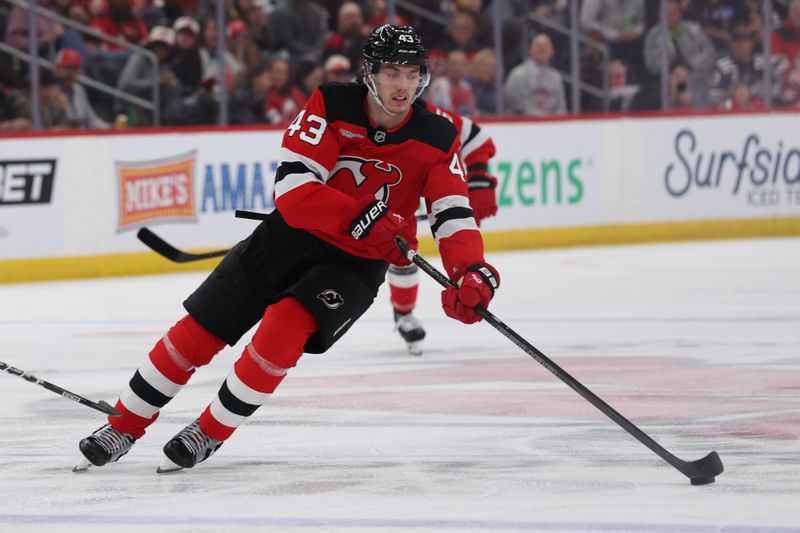 Mar 8, 2026; Newark, New Jersey, USA;  New Jersey Devils defenseman Luke Hughes (43) moves the puck up ice against the Detroit Red Wings during the second period at Prudential Center. Mandatory Credit: Thomas Salus-Imagn Images