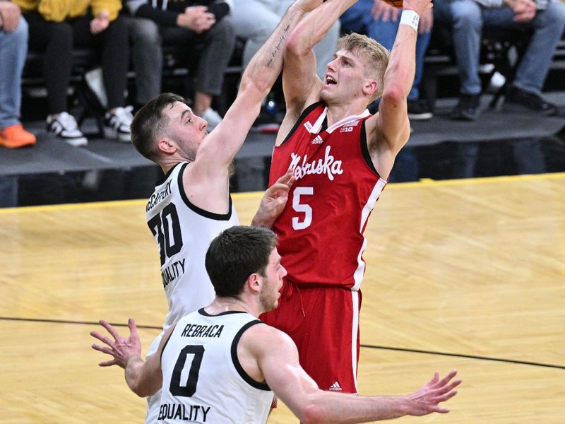 Mar 5, 2023; Iowa City, Iowa, USA; Nebraska Cornhuskers guard Sam Griesel (5) shoots the ball over Iowa Hawkeyes forward Filip Rebraca (0) and guard Connor McCaffery (30) during the first half at Carver-Hawkeye Arena. Mandatory Credit: Jeffrey Becker-USA TODAY Sports