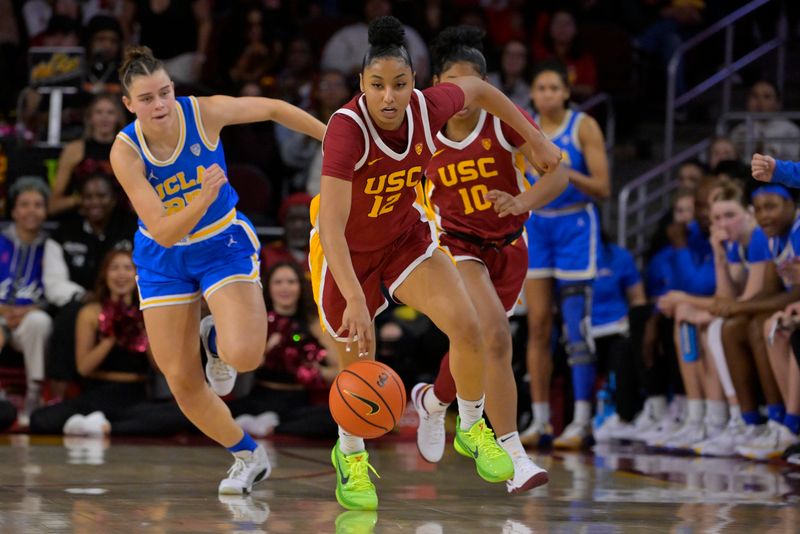 Jan 14, 2024; Los Angeles, California, USA; USC Trojans guard JuJu Watkins (12) beats UCLA Bruins forward Gabriela Jaquez (23) to the ball in the second half at Galen Center. Mandatory Credit: Jayne Kamin-Oncea-USA TODAY Sports