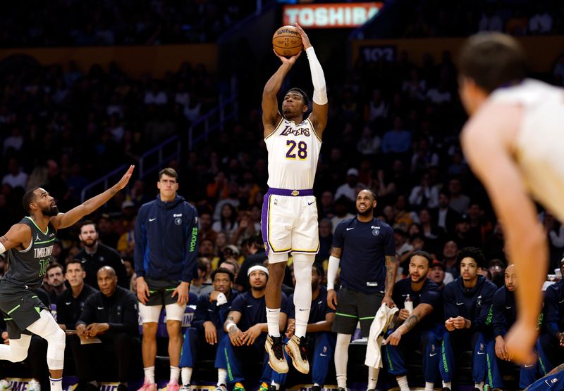 LOS ANGELES, CALIFORNIA - APRIL 7: Rui Hachimura #28 of the Los Angeles Lakers shoots and scores a three-point basket against Mike Conley #10 of the Minnesota Timberwolves during the first half at Crypto.com Arena on April 7, 2024 in Los Angeles, California. NOTE TO USER: User expressly acknowledges and agrees that, by downloading and or using this photograph, User is consenting to the terms and conditions of the Getty Images License Agreement. (Photo by Kevork Djansezian/Getty Images)