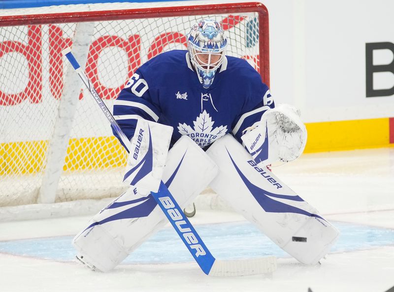 Oct 24, 2024; Toronto, Ontario, CAN; Toronto Maple Leafs goaltender Joseph Woll (60) goes to make a save during warm up before a game against the St. Louis Blues at Scotiabank Arena. Mandatory Credit: John E. Sokolowski-Imagn Images