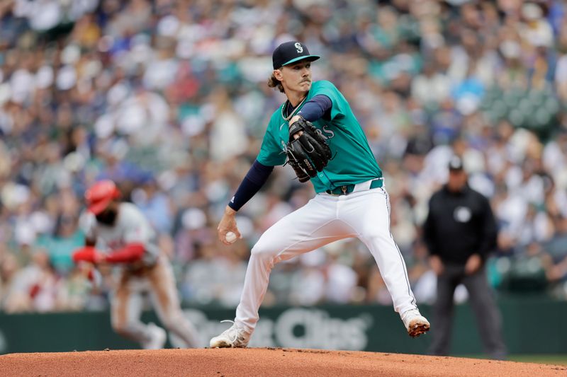 Jun 1, 2024; Seattle, Washington, USA;  Seattle Mariners starting pitcher Bryce Miller (50) winds up as Los Angeles Angels second baseman Luis Rengifo (2) starts a steal attempt behind, but was out during the first inning at T-Mobile Park. Mandatory Credit: John Froschauer-USA TODAY Sports
