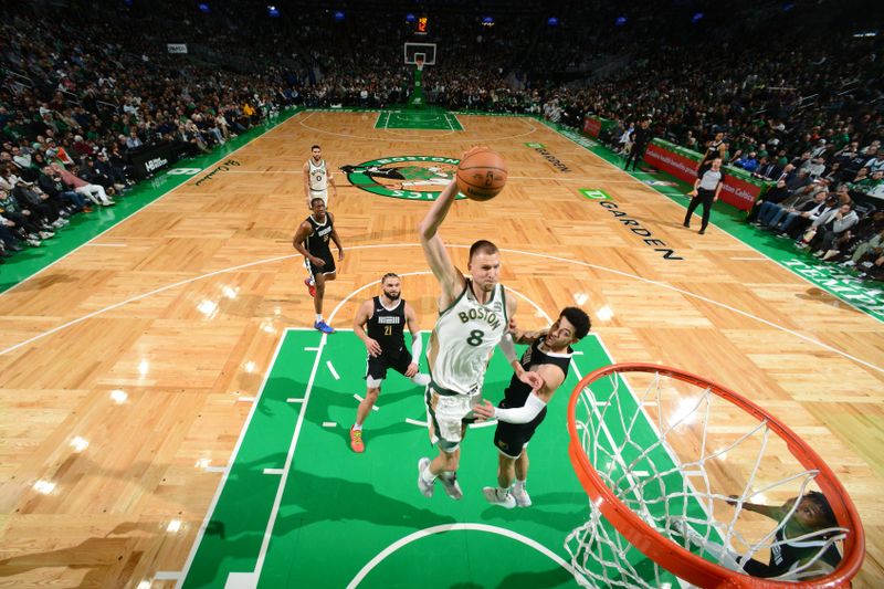 BOSTON, MA - FEBRUARY 4:  Kristaps Porzingis #8 of the Boston Celtics drives to the basket during the game  against the Memphis Grizzlies on February 4, 2024 at the TD Garden in Boston, Massachusetts. NOTE TO USER: User expressly acknowledges and agrees that, by downloading and or using this photograph, User is consenting to the terms and conditions of the Getty Images License Agreement. Mandatory Copyright Notice: Copyright 2024 NBAE  (Photo by Brian Babineau/NBAE via Getty Images)