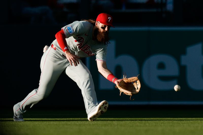 May 20, 2025; Denver, Colorado, USA; Philadelphia Phillies center fielder Brandon Marsh (16) fields the ball in the second inning against the Colorado Rockies at Coors Field. Mandatory Credit: Isaiah J. Downing-Imagn Images