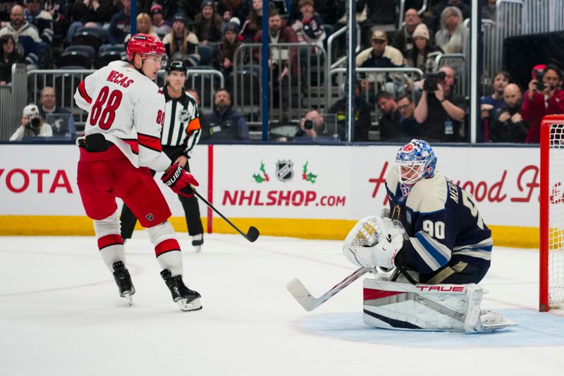 Nov 23, 2024; Columbus, Ohio, USA;  Columbus Blue Jackets goaltender Elvis Merzlikins (90) makes a save in net against Carolina Hurricanes center Martin Necas (88) in the shootout at Nationwide Arena. Mandatory Credit: Aaron Doster-Imagn Images