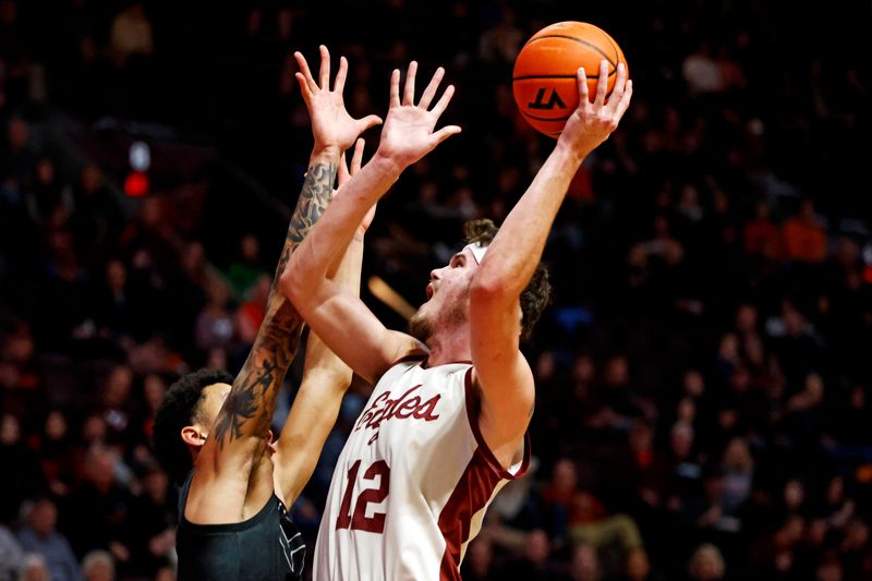 Jan 23, 2024; Blacksburg, Virginia, USA; Boston College Eagles forward Quinten Post (12) shoots the ball against Virginia Tech Hokies center Lynn Kidd (15) during the first half at Cassell Coliseum. Mandatory Credit: Peter Casey-USA TODAY Sports