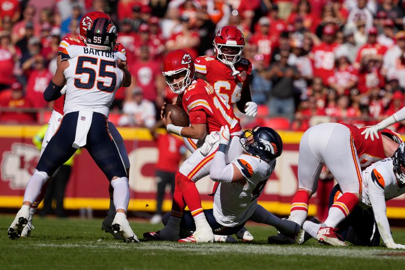 Kansas City Chiefs quarterback Patrick Mahomes (15) is sacked by Denver Broncos defensive end Zach Allen during the first half of an NFL football game Sunday, Nov. 10, 2024, in Kansas City, Mo. (AP Photo/Ed Zurga)