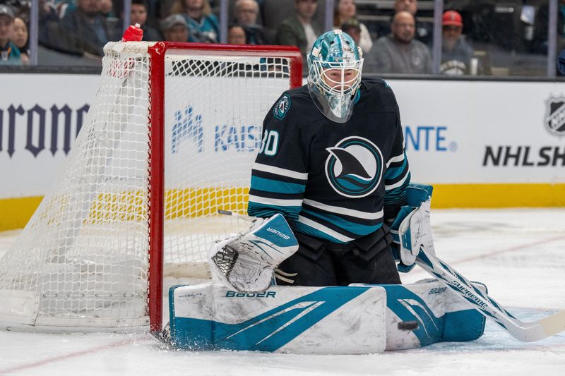 Jan 23, 2025; San Jose, California, USA;  San Jose Sharks goaltender Yaroslav Askarov (30) makes a save against the Nashville Predators during the first period at SAP Center at San Jose. Mandatory Credit: Neville E. Guard-Imagn Images