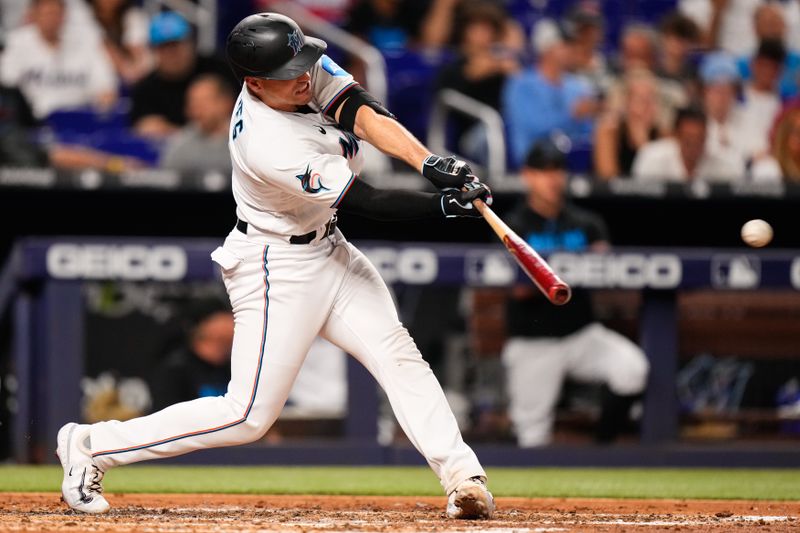 Jun 20, 2023; Miami, Florida, USA; Miami Marlins catcher Nick Fortes (4) hits a single against the Toronto Blue Jays during the sixth inning at loanDepot Park. Mandatory Credit: Rich Storry-USA TODAY Sports