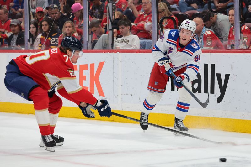 Apr 13, 2026; Sunrise, Florida, USA; New York Rangers right wing Gabe Perreault (94) moves the puck against Florida Panthers defenseman Dmitry Kulikov (7) during the second period at Amerant Bank Arena. Mandatory Credit: Sam Navarro-Imagn Images
