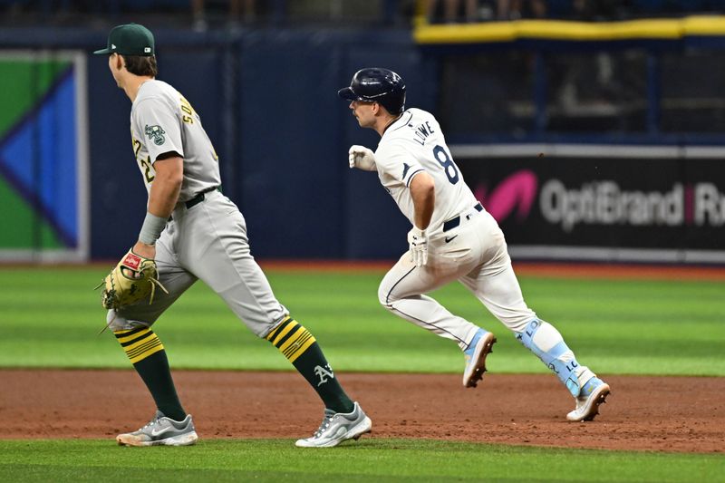 May 29, 2024; St. Petersburg, Florida, USA; Tampa Bay Rays second baseman Brandon Lowe (8) hits a double in the sixth inning against the Oakland Athletics at Tropicana Field. Mandatory Credit: Jonathan Dyer-USA TODAY Sports