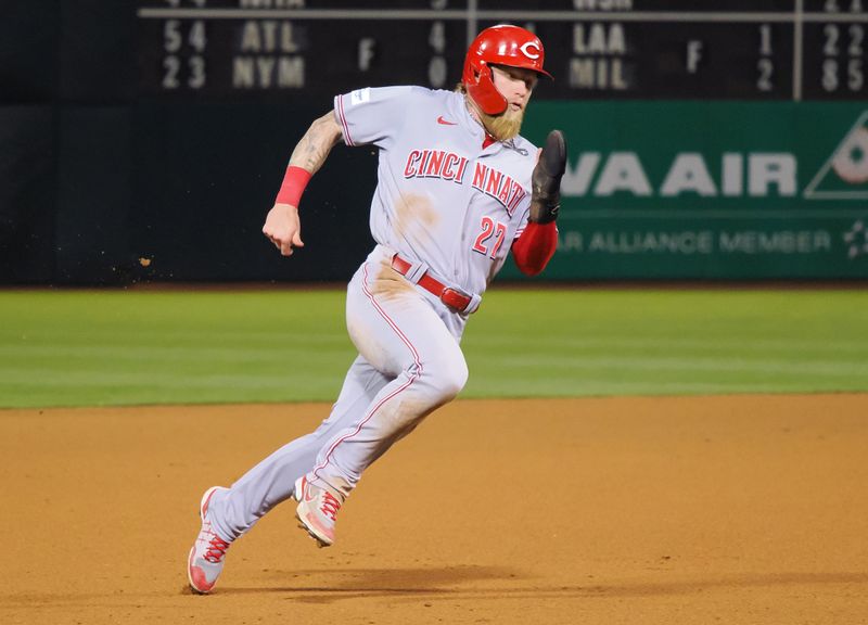 Apr 28, 2023; Oakland, California, USA; Cincinnati Reds outfielder Jake Fraley (27) rounds the bases to score a run against the Oakland Athletics during the seventh inning at Oakland Coliseum. Mandatory Credit: Kelley L Cox-USA TODAY Sports