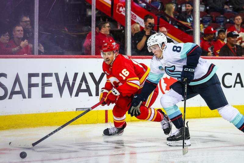 Sep 23, 2025; Calgary, Alberta, CAN; Calgary Flames center Morgan Frost (16) and Seattle Kraken defenseman Cale Fleury (8) battles for the puck during the second period at Scotiabank Saddledome. Mandatory Credit: Sergei Belski-Imagn Images
