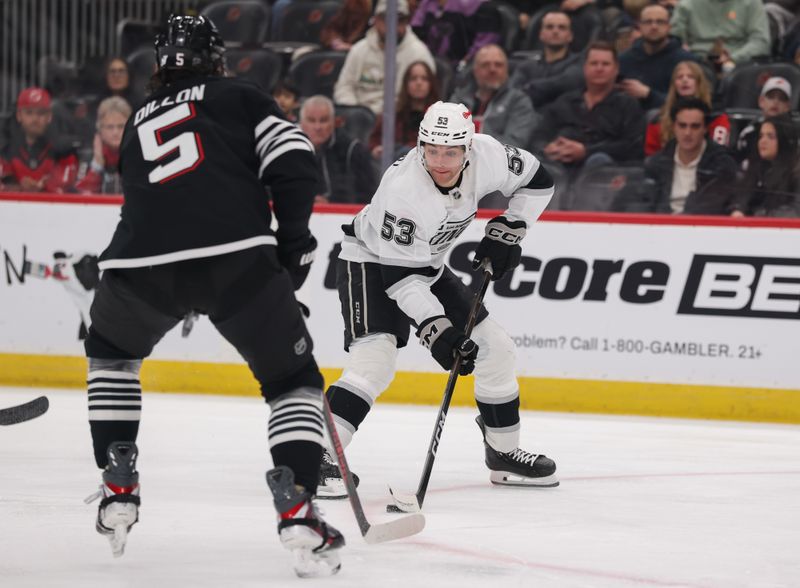 Mar 14, 2026; Newark, New Jersey, USA; Los Angeles Kings right wing Jared Wright (53) skates with the puck while being defended by New Jersey Devils defenseman Brenden Dillon (5) during the first period at Prudential Center. Mandatory Credit: Ed Mulholland-Imagn Images Mar 14, 2026; Newark, New Jersey, USA; Los Angeles Kings right wing Jared Wright (53) skates with the puck while being defended by New Jersey Devils defenseman Brenden Dillon (5) during the first period at Prudential Center. Mandatory Credit: Ed Mulholland-Imagn Images