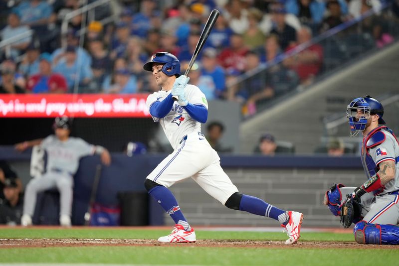 Jul 26, 2024; Toronto, Ontario, CAN; Toronto Blue Jays third baseman Ernie Clement (28) hits a walk off single to win the game against the Texas Rangers in the ninth inning at Rogers Centre. Mandatory Credit: John E. Sokolowski-USA TODAY Sports