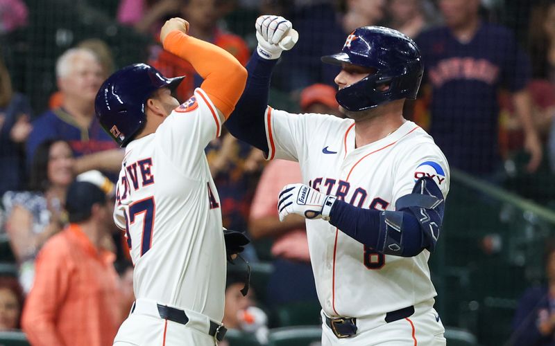 May 27, 2025; Houston, Texas, USA; Houston Astros designated hitter Jose Altuve (27) celebrates with first baseman Christian Walker (8) after a two-run home run against the Athletics in the sixth inning at Daikin Park. Mandatory Credit: Thomas Shea-Imagn Images
