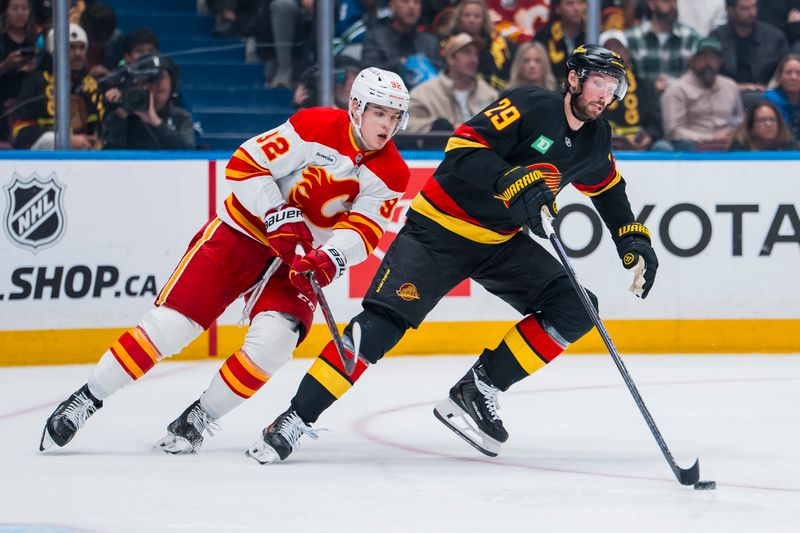 Oct 9, 2025; Vancouver, British Columbia, CAN; Calgary Flames forward Matvei Gridin (92) pursues Vancouver Canucks defenseman Marcus Pettersson (29) in the third period at Rogers Arena. Mandatory Credit: Bob Frid-Imagn Images